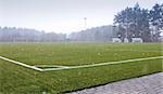 Football / soccer playground and snow showers in the spring