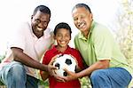 Grandfather With Son And Grandson In Park With Football