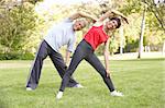 Senior Couple Exercising In Park