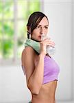 Beautiful sporty woman drinking water and doing sport