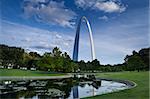 Gateway Arch, trees, and lake in the Jefferson National Expansion Memorial in St. Louis, MO