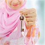 Muslim woman hand holding a new key