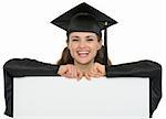 Happy graduation student girl with blank billboard