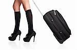 Businesswoman s legs in high stockings and high heels, holding a black suitcase