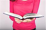 woman white shirt detail holding an open book