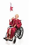 Disabled senior woman graduating college, tosses her cap in the air.  Full body isolated on white.