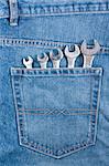 Blue jeans pocket with five chrome wrenches