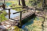 Wooden bridge on the path beside the Elsa river, Tuscany, Italy.