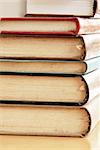 old dusty closed books stack on table