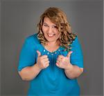 cheerful fat woman on gray background
