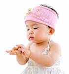 Cute pan Asian baby girl eating on white background
