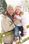 Father And Daughter Standing Outside In Snowy Landscape