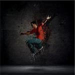 Abstract grunge man dancing against a dark brick wall