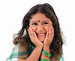 Young little Asian Indian girl smiling on white background