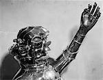 1930s 1940s METAL ROBOT HEAD AND CHEST WITH ONE ARM RAISED AND MOUTH IN A SCOWL