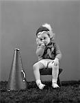 1940s UNHAPPY LITTLE GIRL CHEERLEADER WEARING A CAP AND VARSITY SWEATER FRUSTRATED SAD LOOK