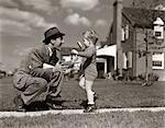 1940s FATHER GREETING SON RUNNING TOWARDS HIM ON SIDEWALK