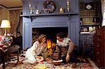 FAMILY SITTING BY FIREPLACE