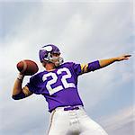 1970s AMERICAN FOOTBALL PLAYER PURPLE JERSEY 22 ABOUT TO THROW THE BALL