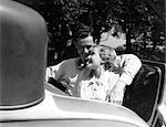 1930s COUPLE IN BACK RUMBLE SEAT REAR OF CAR MAN WITH ARM AROUND WOMAN