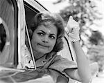 1950s 1960s PORTRAIT OF ANGRY WOMAN DRIVER GESTURING WITH GLOVED HAND