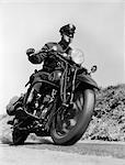 1930s BLURRED ACTION SHOT OF MOTORCYCLE POLICEMAN DRIVING FAST BLOWING WHISTLE