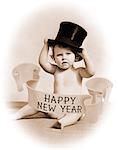 1930s BABY WEARING TOP HAT SURROUNDED BY HAPPY NEW YEAR BANNER LOOKING AT CAMERA