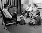 1960s 3 GENERATION FAMILY WATCHING TELEVISION