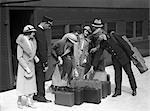 1920s 1930s TRAVELERS ON TRAIN PLATFORM IDENTIFYING LUGGAGE FOR PORTER
