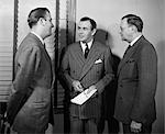 1940s 1950s THREE BUSINESSMEN SALESMEN TALKING TOGETHER IN OFFICE