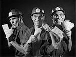 1950s 1960s GRAPHIC EFFECT TRIPLE EXPOSURE SHOWING MAN HARDHAT WORKER READING PAY ENVELOPE OPENING IT SHOWING CASH SMILING