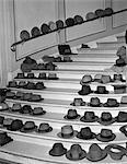 1950s MEN'S HATS COATS LINED UP ON LARGE STAIRWAY INDOOR