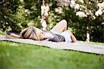 Woman laying on blanket in park