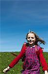 Smiling girl wearing backpack outdoors