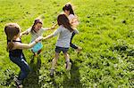 Girls playing in circle outdoors