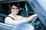 Smiling woman driving car