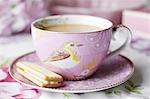 Close up of cup of tea and cookie