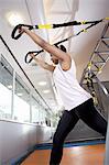 Teenage girl exercising in gym