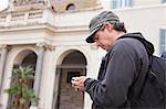 Man using cell phone on city street