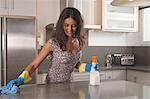 Woman cleaning kitchen counter