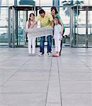 Family with map outside airport