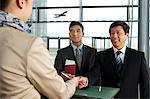 Businessmen checking in at airport