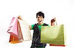 Portrait of a young man posing with shopping bags