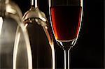 Close-up of glass of wine and two empty glasses