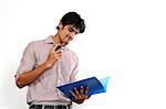 Portrait of man holding file and mobile phone