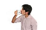 Portrait of man kissing coffee cup