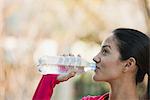 Young woman drinking bottle of water