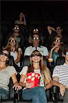 Audience wearing 3-D glasses in movie theater