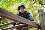 Boy playing on jungle gym