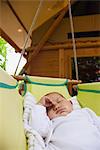 Baby napping in cradle outdoors